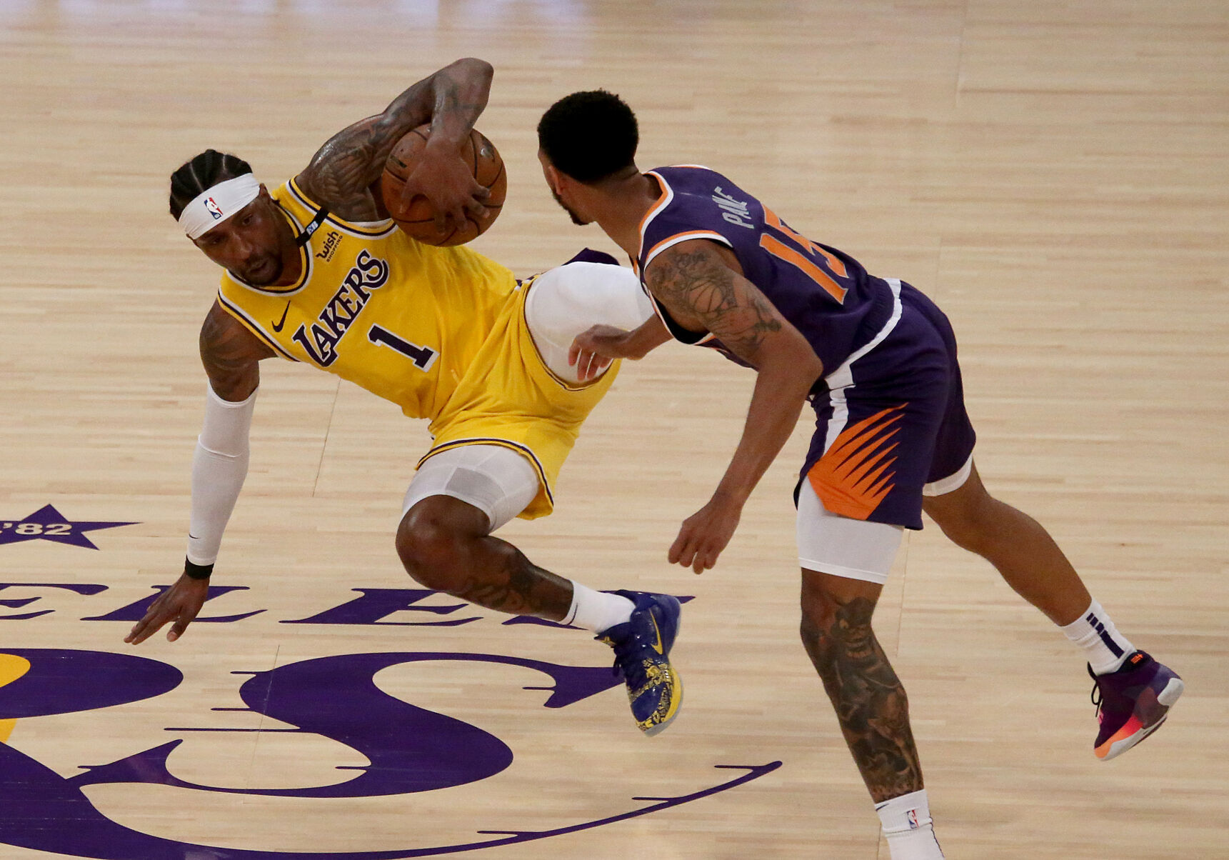 The Los Angeles Lakers' Kentavious Caldwell-Pope battles for control of the ball with the Phoenix Suns' Cameron Payne during the second quarter in Game 6 of the Western Conference first-round series at Staples Center on Thursday, June 3, 2021 in Los Angeles.